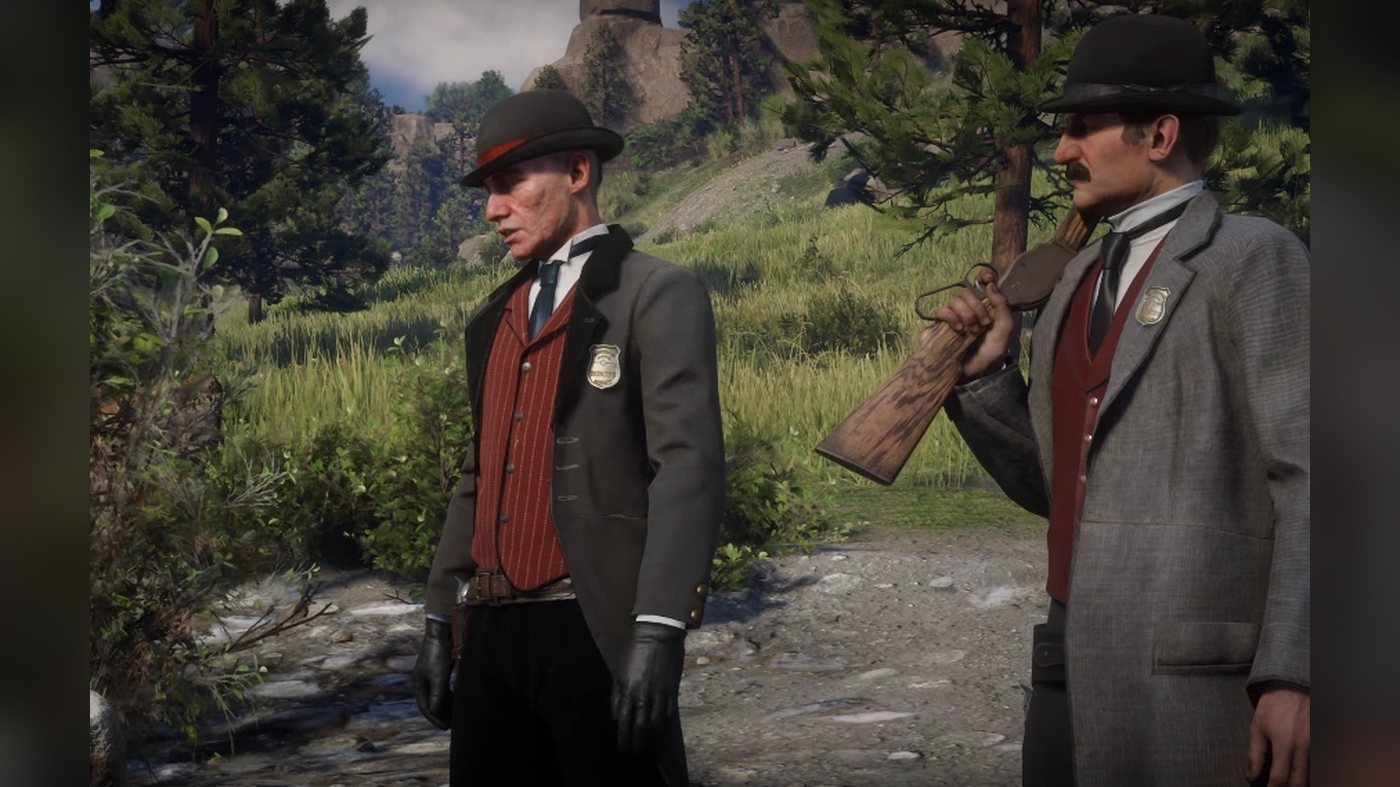 Two agents standing on a forest trail