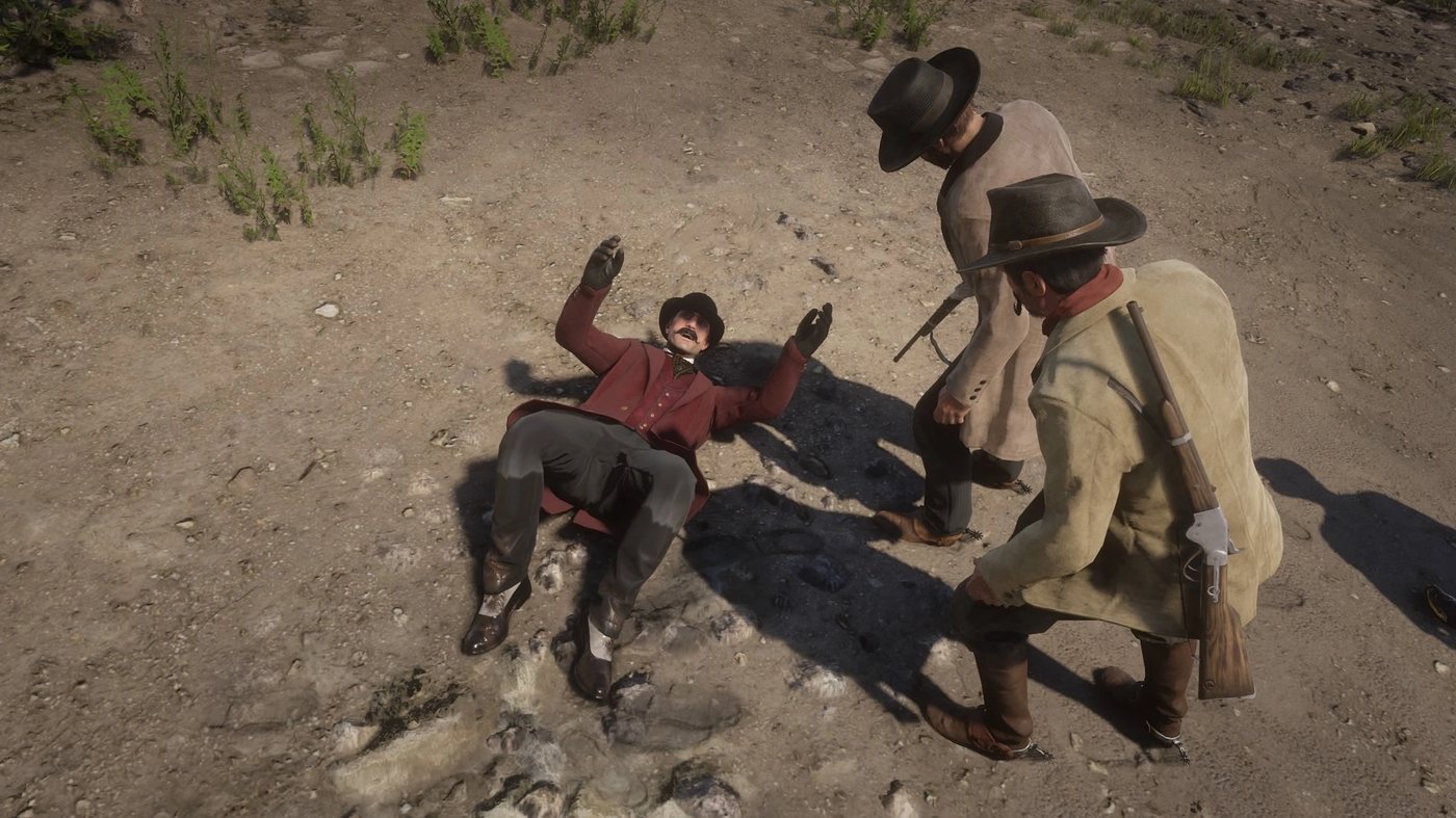 Trelawny lying on the ground in front of two men