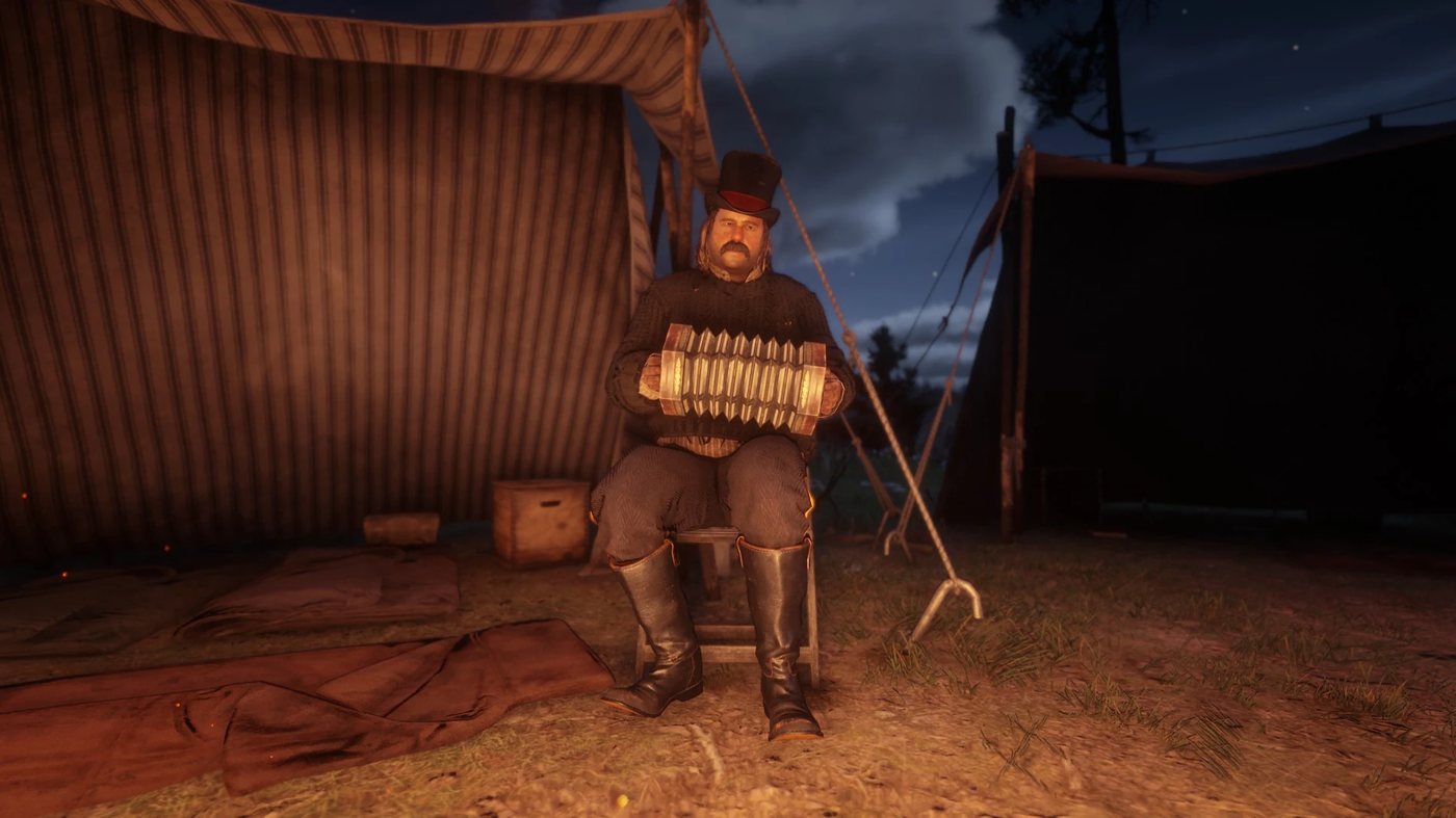 Pearson playing an accordion by a tent at night