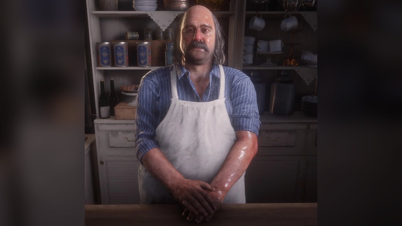 Pearson in an apron behind a store counter