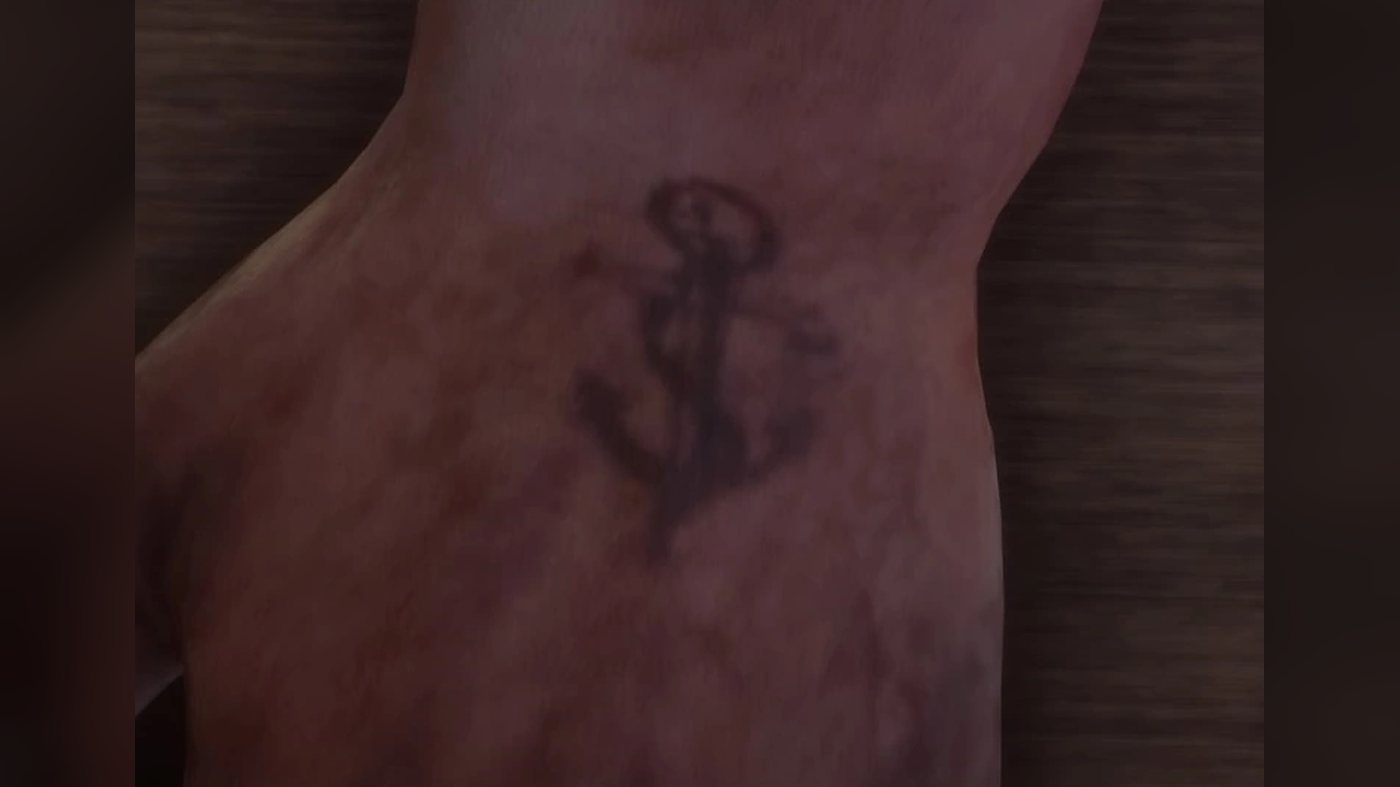 An anchor tattoo on the back of Pearson's hand