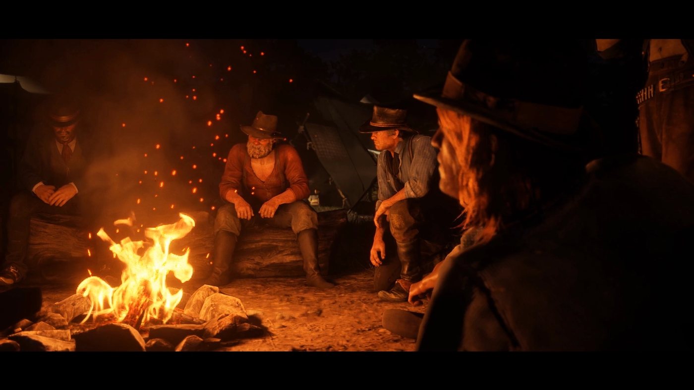 Javier, Uncle and Arthur around a campfire at night
